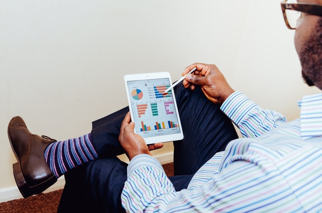 person looking at charts on a tablet