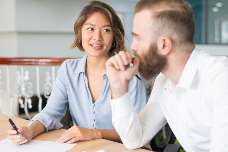 Confident consultant explaining customer document details. Serious boss instructing assistant who writing notes. Consulting concept