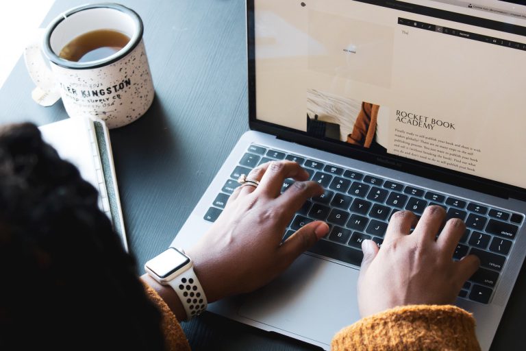 woman typing on laptop keyboard