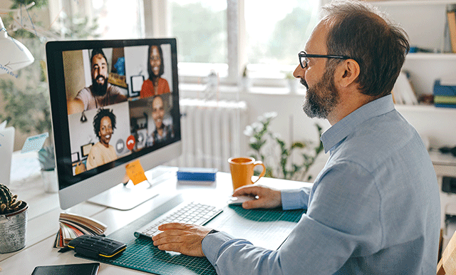 man on zoom call at desk