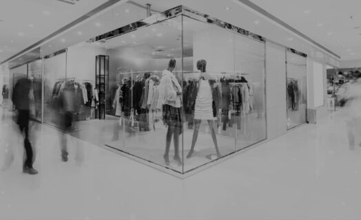 Boutique display window with mannequins in fashionable dresses long exposure in a mall