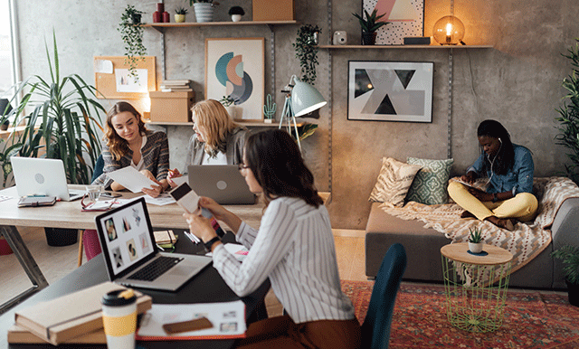 group of people working in a boho office setting