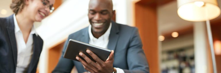 two people looking at a video