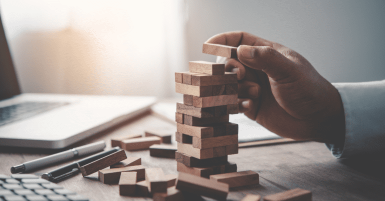Someone playing a miniture game of jenga