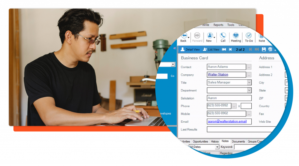 man typing on laptop and filling out form